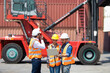 © NVB Stocker - Hispanic man harbor worker talking on the walkie-talkie radio and control loading containers at container warehouse. container yard port of import and export goods