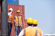 © NVB Stocker - Strike of workers in container yard. Group of multiethnic engineer people during a protest in workplace