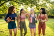© Rosie - Group of Women Laughing and Walking in Park After Yoga Class or Fitness Workout