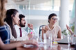 © .shock - Business team meeting in modern office with diverse colleagues collaborating around conference table