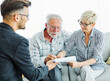 © Lumos sp - Happy senior old family couple clients make financial insurance estate business deal contract signing, agent lawyer, satisfied mature customers sogning contract meeting bank manager agree on investmen