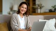 © StudioFF - Cheerful Woman Relaxing with a Laptop Indoors / 屋内でパソコンを使いながらリラックスする明るい女性