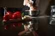 © Taras Grebinets - Chef Preparing Dough in Kitchen With Fresh Tomatoes and Spring Onions on Cutting Board