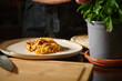 © Taras Grebinets - Steaming Homemade Lasagna Served on a Ceramic Plate Next to Fresh Basil