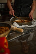 © Taras Grebinets - Home Baker Spreading Savory Filling Into Pastry Tin In Rustic Kitchen