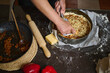 © Taras Grebinets - Hands Preparing Homemade Savory Pie With Cheese And Vegetables On Kitchen Counter