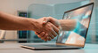 © Arlen - Online deal, online sales, remote employment, digital handshake between human hand and virtual hand emerging from laptop screen, IT, global connection, trust in online business, remote collaboration