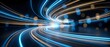 © Yuliia - Dynamic light trails creating swirling motion patterns with blue and orange glowing streaks on dark background for technology and speed concepts.