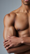 © Curioso.Photography - Close-up of a muscular male torso with defined chest and arms against a neutral background.