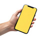 © Momota122 - A hand holding a smartphone displaying a yellow screen