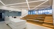 © mochalfin - Modern office interior with linear lighting wooden steps and natural light