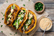 © Carey - Top down view of smash burger tacos with fresh toppings, ready for eating.