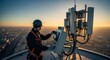 © Margarita Ratatosk - Telecommunication engineer adjusts network antennas on high building rooftop, providing high speed 5g internet to city at sunset for connection technology