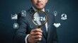 © Funster - Concept of future vision: A businessman holds a magnifying glass over 2026, highlighting technology trends, innovation, analytics, and global strategy.
