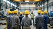 © Funster - A group of employees in safety gear focuses on their supervisor during a workplace safety training session at a manufacturing plant.