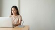 © Tonton1541 - Southeast Asia Remote Learning concept. Woman working on laptop at desk with notebook in minimal office space