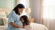 © Jian - Mother's Day pregnant woman with toddler daughter kissing belly in bedroom expressing sibling love anticipation for lifestyle magazine editorial content