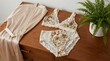 © Sasirat - Elegant Floral Lingerie Set on Wooden Dresser with Silky Robe
