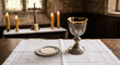 © slowlife kim - Holy communion bread and silver chalice of wine on white linen.