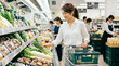 © Stock Photo - スーパーで野菜を選ぶ女性・日常の買い物と健康的な食生活