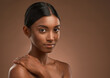 © peopleimages.com - Beauty, wellness and skincare with portrait of woman in studio for cosmetics, dermatology and facial. Glow, self care and space with person on brown background for spa aesthetic, shine and makeup