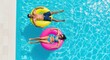 © GHM_STUDIO - Couple relax on inflatable rings in a clear swimming pool. A vibrant aerial view full of enjoyment. Summertime fun, leisure lifestyle, poolside relaxation.
