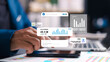 © phimprapha - Business professional using smartphone with virtual dashboard, analyzing social media metrics and data for digital marketing strategy and growth.