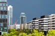© yaqui_villegas - Residential apartment construction in Gallus Europaviertel Frankfurt as cranes rise against storm clouds and a wide city skyline in summer