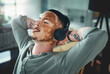 © peopleimages.com - Man, headphones and relax at office with smile, relief or complete project with streaming at media company. Person with vitiligo, happy and listen to music on break, done and audio at creative agency