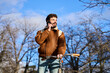 © Oscar - Young man talking on phone, holding bicycle