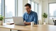 © Svitlana - A man working on a laptop at a desk in a bright office, clean setup, focused expression and natural daylight, ultra-realistic, no logos.