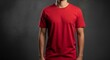 © Velvet - Man wearing a plain red t-shirt with short sleeves against a dark textured studio background front view