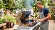 © Xenia - Smiling man flipping burgers on a gas grill at a backyard barbecue party. Summer outdoor cooking and social gathering concept. Man in apron grilling meat for friends