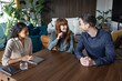 © ReeldealHD images - Couple meeting with a personal advisor to discuss finances