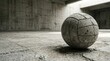 © tsinik - Realistic concrete volleyball with segmented texture rests on cracked concrete floor in spacious industrial hall with concrete walls. Natural directional light creates soft shadows. Monochrome sports