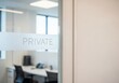© LEXI - Private office interior through glass door in modern building
