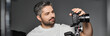 © LIGHTFIELD STUDIOS - Creative man capturing moments with camera in a modern studio setting