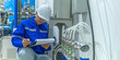 © reewungjunerr - Asian engineer working at Operating hall,Thailand people wear helmet  work,He worked with diligence and patience,she checked the valve regulator at the hydrogen tank.
