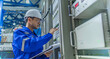 © reewungjunerr - Electrical engineer woman checking voltage at the Power Distribution Cabinet in the control room,preventive maintenance Yearly,Thailand Electrician working at company