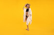 © New Africa - Beautiful woman wearing stylish swimsuit, beach kimono and hat on yellow background