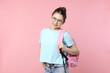 © New Africa - Teenage girl with backpack on pink background
