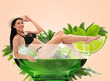 © New Africa - Attractive woman in swimsuit in glass of cocktail against beige background