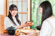 © buritora - A woman enjoying a kaiseki meal at a traditional Japanese inn (in-room dining, kaiseki cuisine, set meal, luxury)