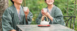 © buritora - A couple in yukata (traditional Japanese summer kimono) enjoying tea while taking a walk in the forest during their trip.