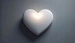 © Imam - A glowing white heart is on a gray surface with a shadow.
