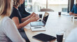 © Talia - Professional business colleagues collaborating and brainstorming during an important meeting in a modern office.