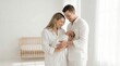 © Digi - Loving parents holding newborn baby in bright nursery