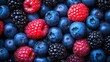© Robbie - filling the frame, a high resolution photograph displays a large collection of ripe berries. the majority are blueberries, exhibiting their classic blue hue and rounded shape, often with a slight inde