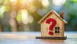 © hardvicore - Miniature wooden house with red question mark, real estate property concept, soft blurred background, home and housing problem