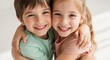 © NN AI - Close up portrait of happy boy and girl hugging. Smiling young children embracing. Sibling bond and friendship concept